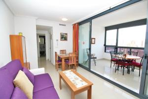 a living room with a purple couch and a table at Apartamento Gema Gemelos 26 in Benidorm