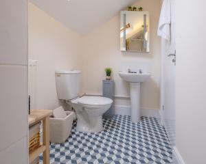 a bathroom with a toilet and a sink at Luxury Living, Stylish Modern Apartment in the Heart of Ryde in Ryde