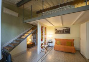- un salon avec un canapé orange et un escalier dans l'établissement Proconsolo Apartment, à Florence