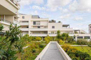an apartment building with a walkway in front of it at Ô de Mer at My Luxury Home in Provence in La Ciotat