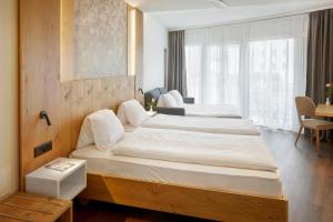 Hotel Rössli Gourmet & Spa tesisinde bir odada yatak veya yataklar