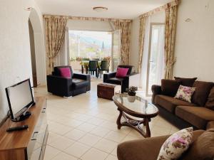 a living room with a couch and a table at Apartments Sneki in Baošići