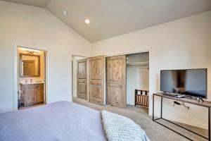 a bedroom with a bed and a flat screen tv at Luxury Mt Bachelor Retreat with Hot Tub and Patio in Bend