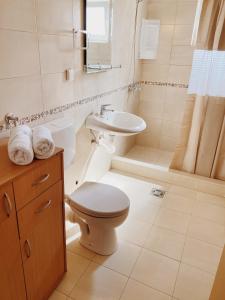 a white bathroom with a toilet and a sink at Apartments Sneki in Baošići +27 photos