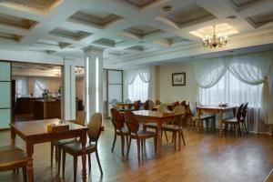 a dining room with wooden tables and chairs at Grand Peterhof Spa Hotel in Petergof