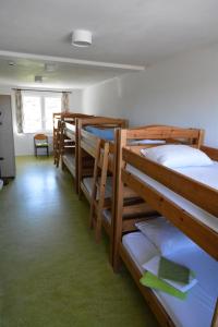 a room with a row of bunk beds at Le Fagotin - Youth hostel in Stoumont