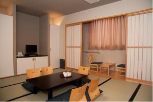 a living room with a dining room table and chairs at Hakata Sunlight Hotel Hinoohgi in Fukuoka