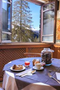 a table with a blue table cloth with food on it at Palace Pontedilegno Resort in Ponte di Legno