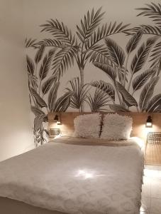 ニースにあるLes Grands Cedresのベッドルーム1室(大型ベッド1台、葉の壁画付)