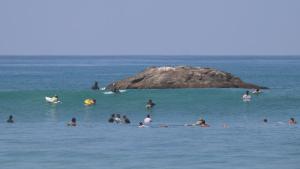 a group of people swimming in the ocean at The Oasis Villa in Ahangama