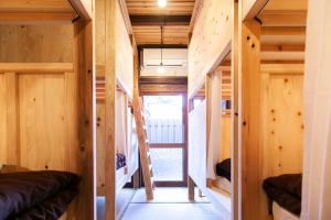 a tiny house with wooden walls and stairs at Fukuoka Guesthouse SHIP in Fukuoka