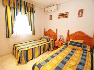 a bedroom with two beds and a window at Holiday Home Tamarit Beach by Interhome in Santa Pola