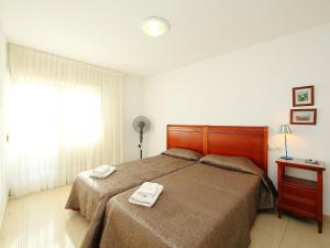 a bedroom with a bed with two towels on it at Apartment Giner by Interhome in Benidorm