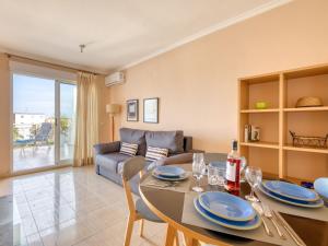 a living room with a dining table and a couch at Apartment Bahia Blanca-1 by Interhome in Denia