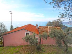 a person sitting on the roof of a house at Holiday Home Ca Dò Sante by Interhome in Zoagli