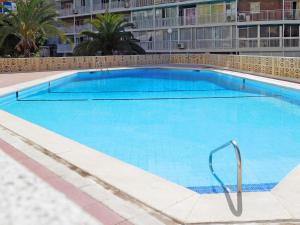 a large blue swimming pool in a building at Apartment Halcon Levante by Interhome in Benidorm