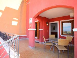 a balcony with a table and chairs in a building at Holiday Home Balcon de Finestrat by Interhome in Finestrat