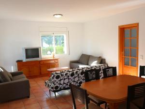 a living room with a couch and a table at Villa Villa Alguer by Interhome in Les tres Cales