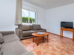 a living room with a couch and a table at Villa Villa Cala Vidre A by Interhome in Les tres Cales