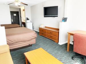 a hotel room with a bed and a flat screen tv at Countryside Suites Lincoln I-80 in Lincoln