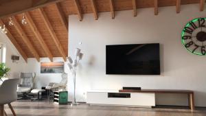 a living room with a flat screen tv on a wall at Stadtvilla Intzeplatz - Apartment Norderney in Remscheid