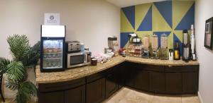 a kitchen with a counter with a microwave and a coffee maker at SureStay Hotel by Best Western Vallejo Napa Valley in Vallejo
