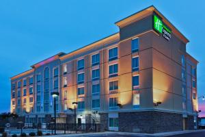 a hotel building with a green sign on it at Holiday Inn Express Hotel & Suites Jackson Northeast by IHG in Jackson