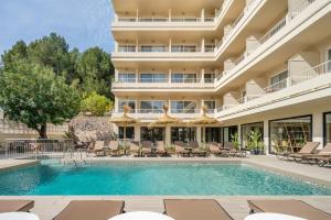 an exterior view of a hotel with a swimming pool at Hotel Eden Nord Soller in Port de Soller