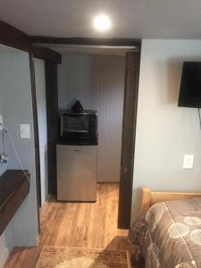 a bedroom with a bed and a microwave in a room at Rooms in My House and Separate Apt on 13th Street Self Catering in Greeley