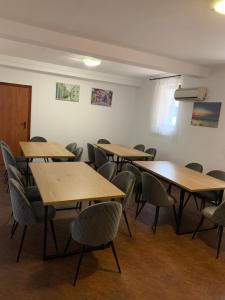 a classroom with tables and chairs in a room at Vila Dedy in Costinesti +52 photos