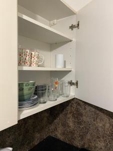 a cupboard with plates and bowls on it at Entire Spacious Family House in Burnley