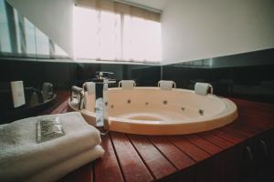 a bath tub in a bathroom with a towel at Provenza Lofts in Medellín