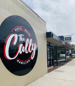 a sign on the side of a building at Caledonian Hotel Motel in Hamilton