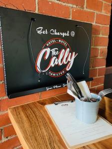 a sign for the candy bar with a cup of utensils at Caledonian Hotel Motel in Hamilton