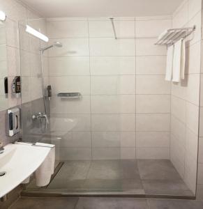 a bathroom with a shower and a sink at ARABEST Aparthotel & Boardinghouse in Munich