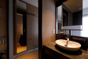 a bathroom with a sink and a mirror at First Hotel Kanazawa in Kanazawa +21 photos