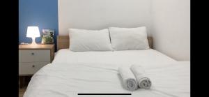 a bedroom with a white bed with towels on it at MUONGTHANH APARMENT OCEAN - 2 Bedrooms in Da Nang