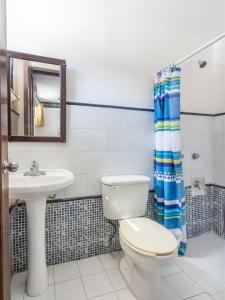 a bathroom with a toilet and a sink at Hotel Rath in Campeche