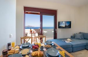 a living room with a table with food on it at Villa PhenΩmena Apartments in Kókkinon Khoríon