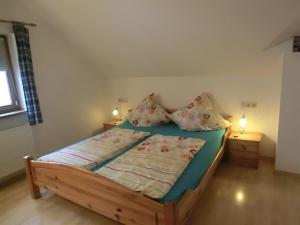 a bedroom with a wooden bed with two night stands at Haus Bagci in Füssen