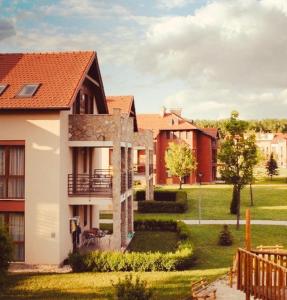 a view of a house with a yard at Birdland Apartman in Bük