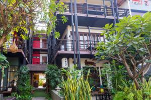a building with a staircase and plants at Le Canal Boutique House in Chiang Mai