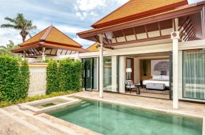 a bathroom with a tub and a balcony at Banyan Tree Phuket - SHA Extra Plus in Bang Tao Beach