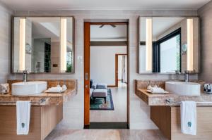 a bathroom with a sink and a mirror at Banyan Tree Phuket - SHA Extra Plus in Bang Tao Beach