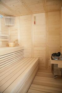 a wooden sauna with a bench and a table at Golden Star City Resort in Perea