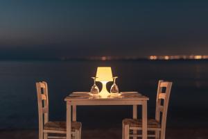 a table with a lamp on it with two chairs at Golden Star City Resort in Perea