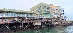 a building on a pier next to the water at Sipadan Inn 2 in Semporna