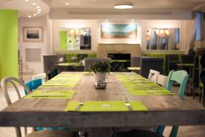a large wooden table in a restaurant with green accents at Golden Star City Resort in Perea