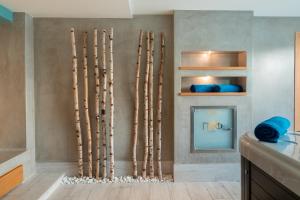 a bathroom with a bunch of bamboo sticks on the wall at Golden Star City Resort in Perea