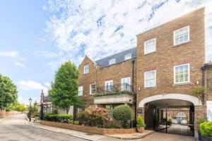 a brick building with a balcony on a street at Richmond - 2 Bed court flat with allocated parking in Richmond